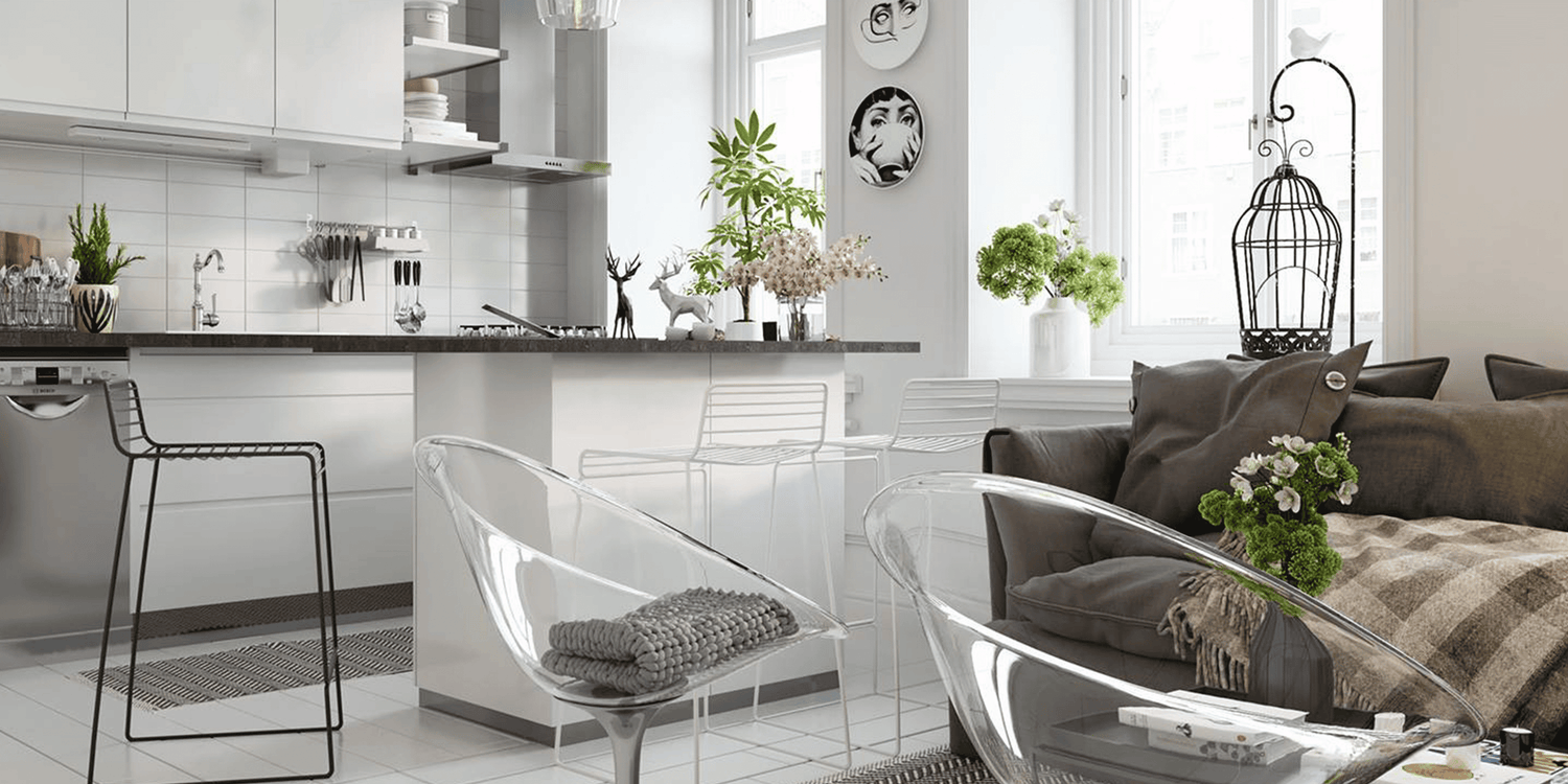 Modern kitchen and living room with gray sofa and decorative elements.