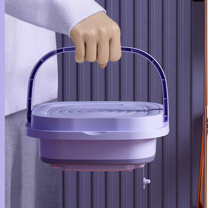 Person holding a purple plastic container with a handle against a neutral background