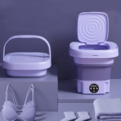 Collapsible purple washing machine with accessories on a purple background